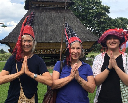 3 women in traditional Indonesian headwear